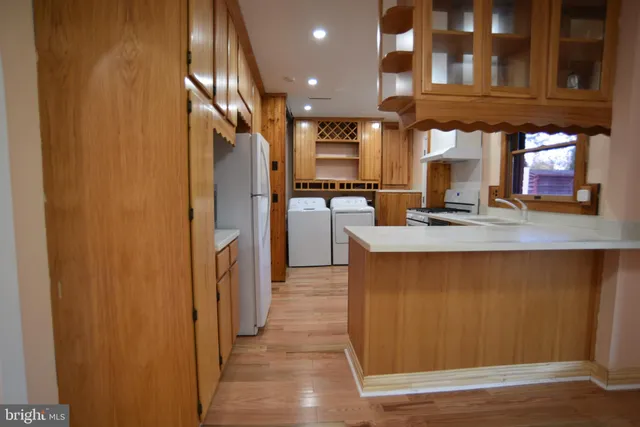 a kitchen with refrigerator and cabinets