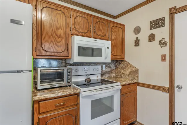 a kitchen with stainless steel appliances wooden cabinets and a stove top oven