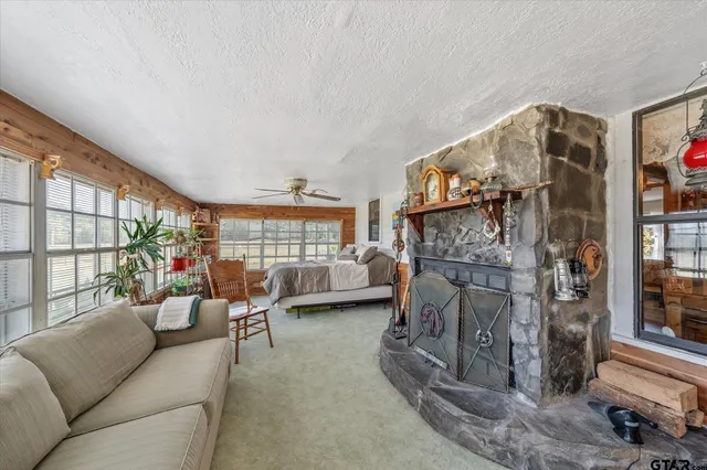 a living room with furniture a fireplace and a large window with outer view