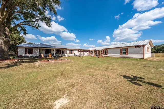 a front view of house with yard and swimming pool