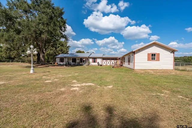 a view of a house with a backyard