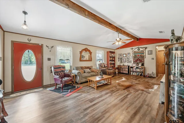 a living room with lots of furniture and a wooden floor