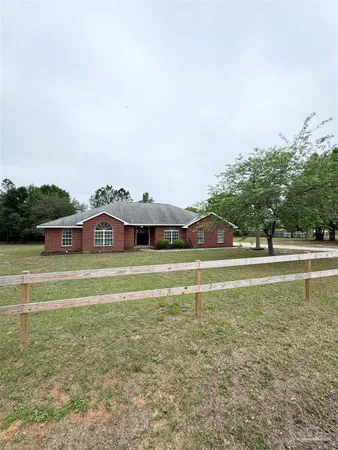 a view of a swimming pool with a yard