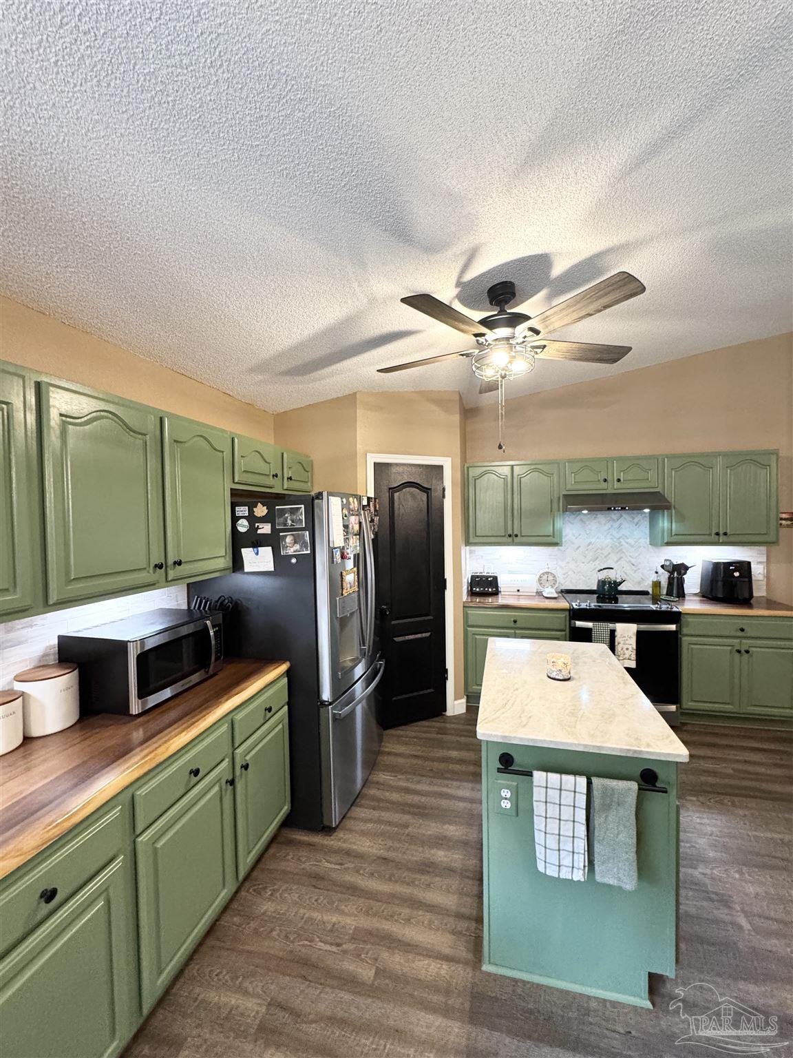 9909 South Trace Road Milton, FL 32583 - Photo 12 of 41 a kitchen with stainless steel appliances a stove a refrigerator and a sink