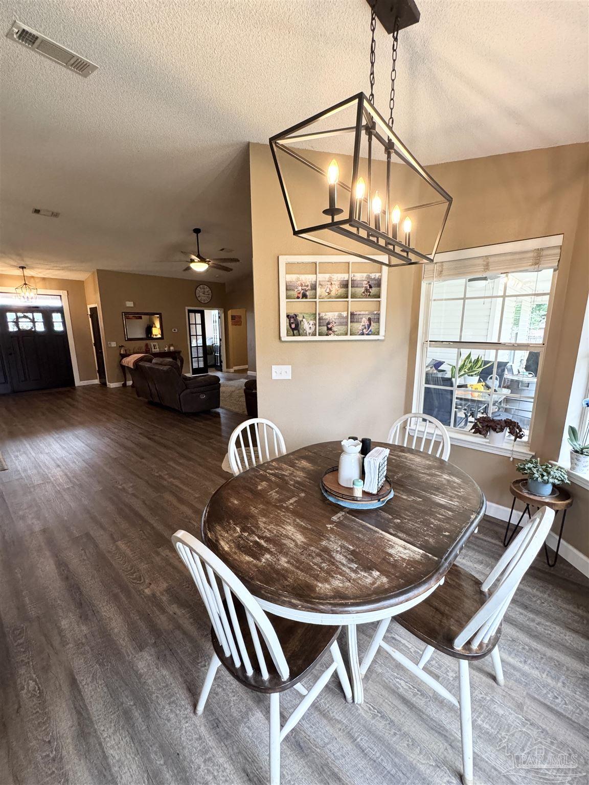 9909 South Trace Road Milton, FL 32583 - Photo 15 of 41 a view of a dining room with furniture