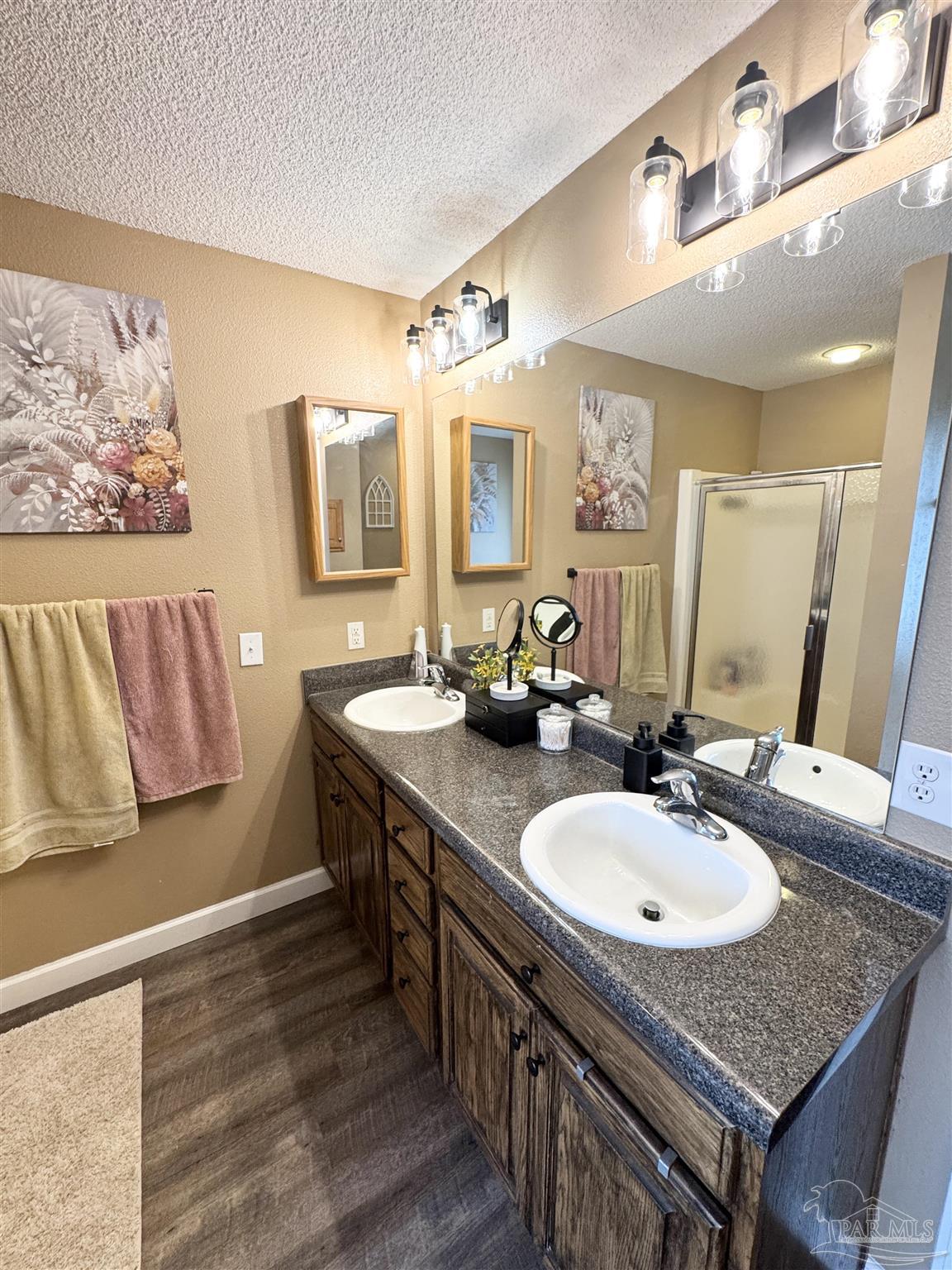 9909 South Trace Road Milton, FL 32583 - Photo 21 of 41 a bathroom with a sink double vanity granite and a mirror