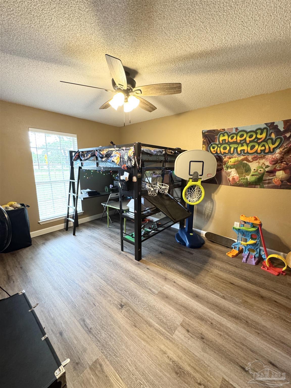 9909 South Trace Road Milton, FL 32583 - Photo 25 of 41 a living room with furniture and a wooden floor