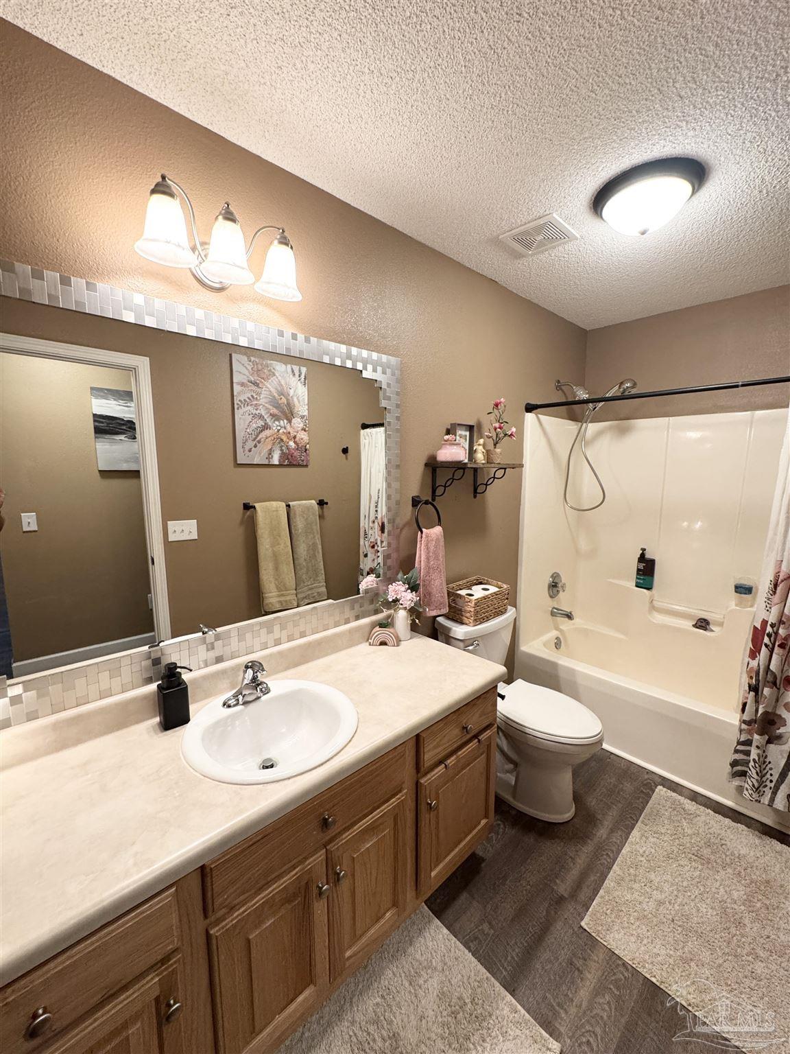 9909 South Trace Road Milton, FL 32583 - Photo 28 of 41 a spacious bathroom with a sink double vanity granite toilet tub and shower