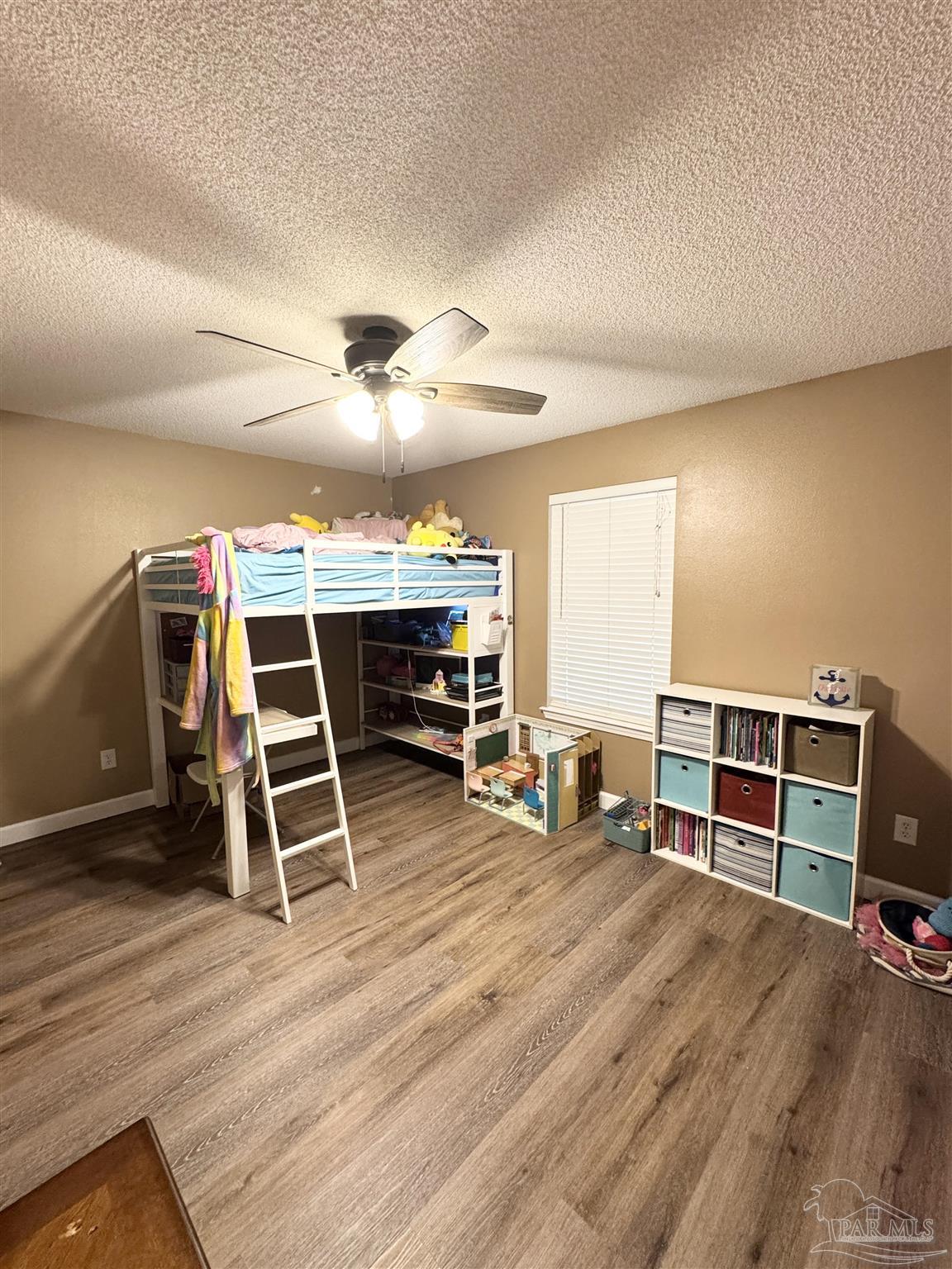 9909 South Trace Road Milton, FL 32583 - Photo 29 of 41 a view of a room with wooden floor and furniture