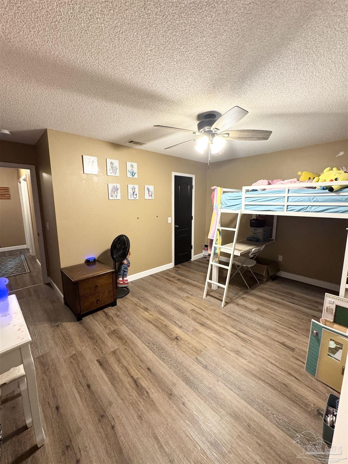 9909 South Trace Road Milton, FL 32583 - Photo 30 of 41 a living room with furniture a flat screen tv and a table