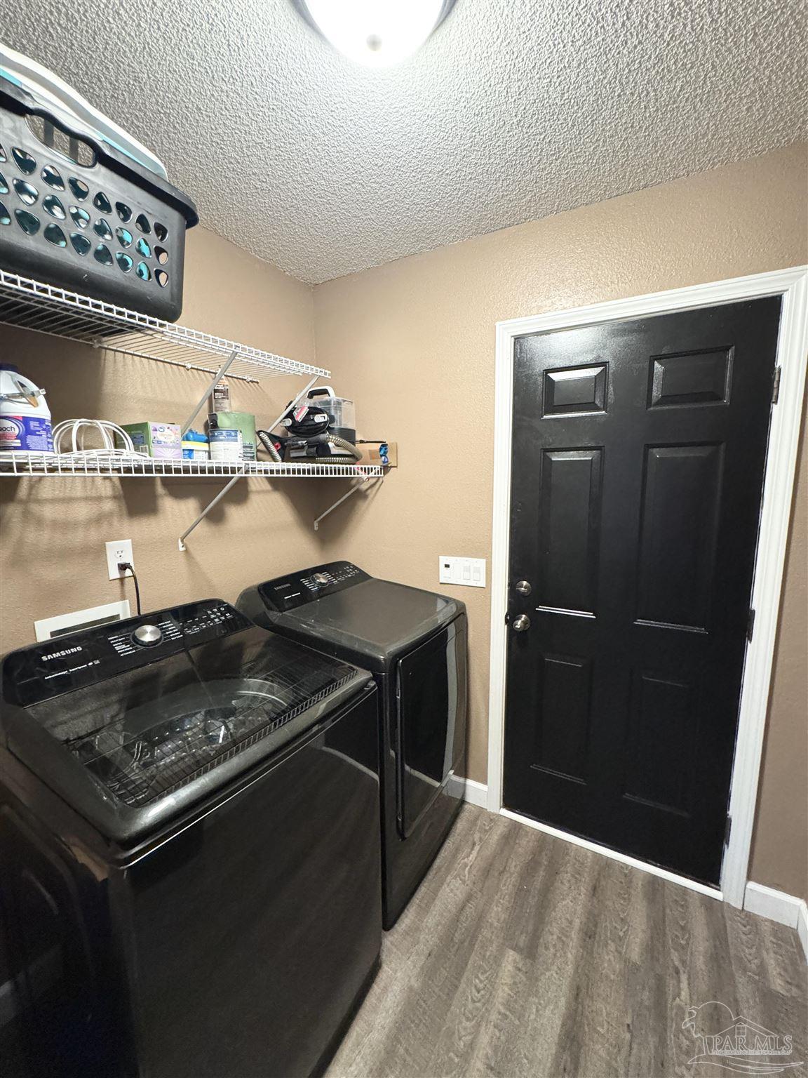 9909 South Trace Road Milton, FL 32583 - Photo 31 of 41 a kitchen with a stove and a refrigerator