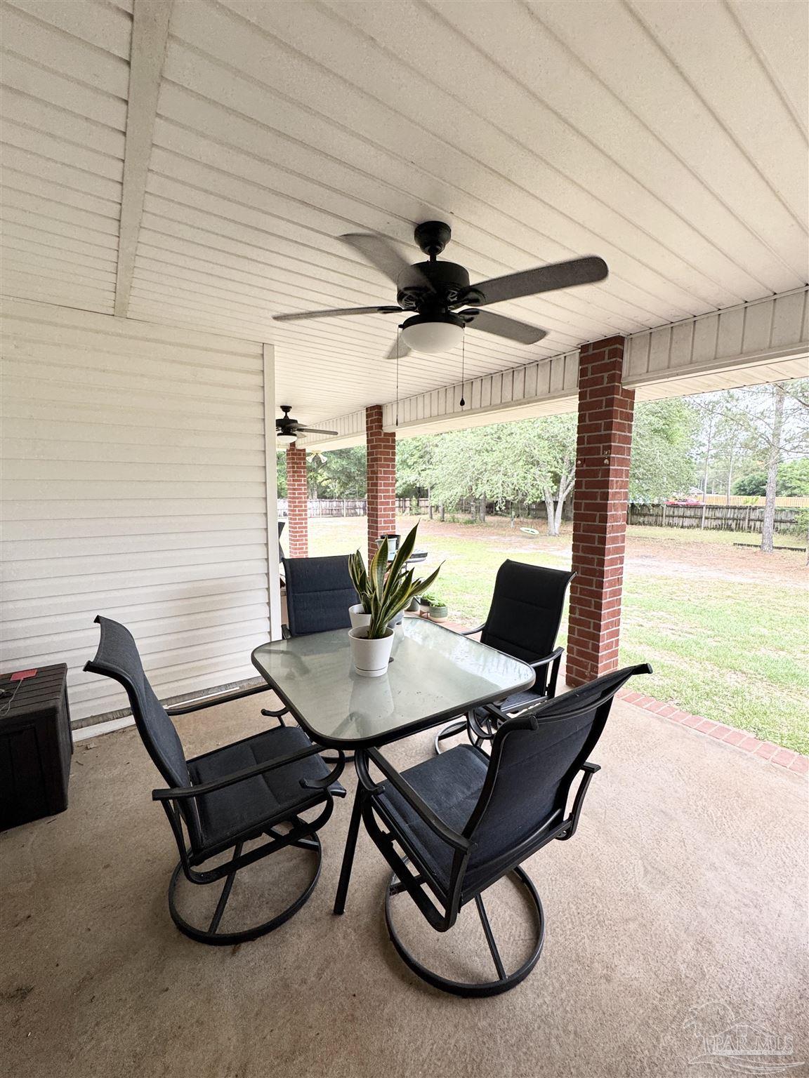 9909 South Trace Road Milton, FL 32583 - Photo 32 of 41 a workspace with furniture and a large window