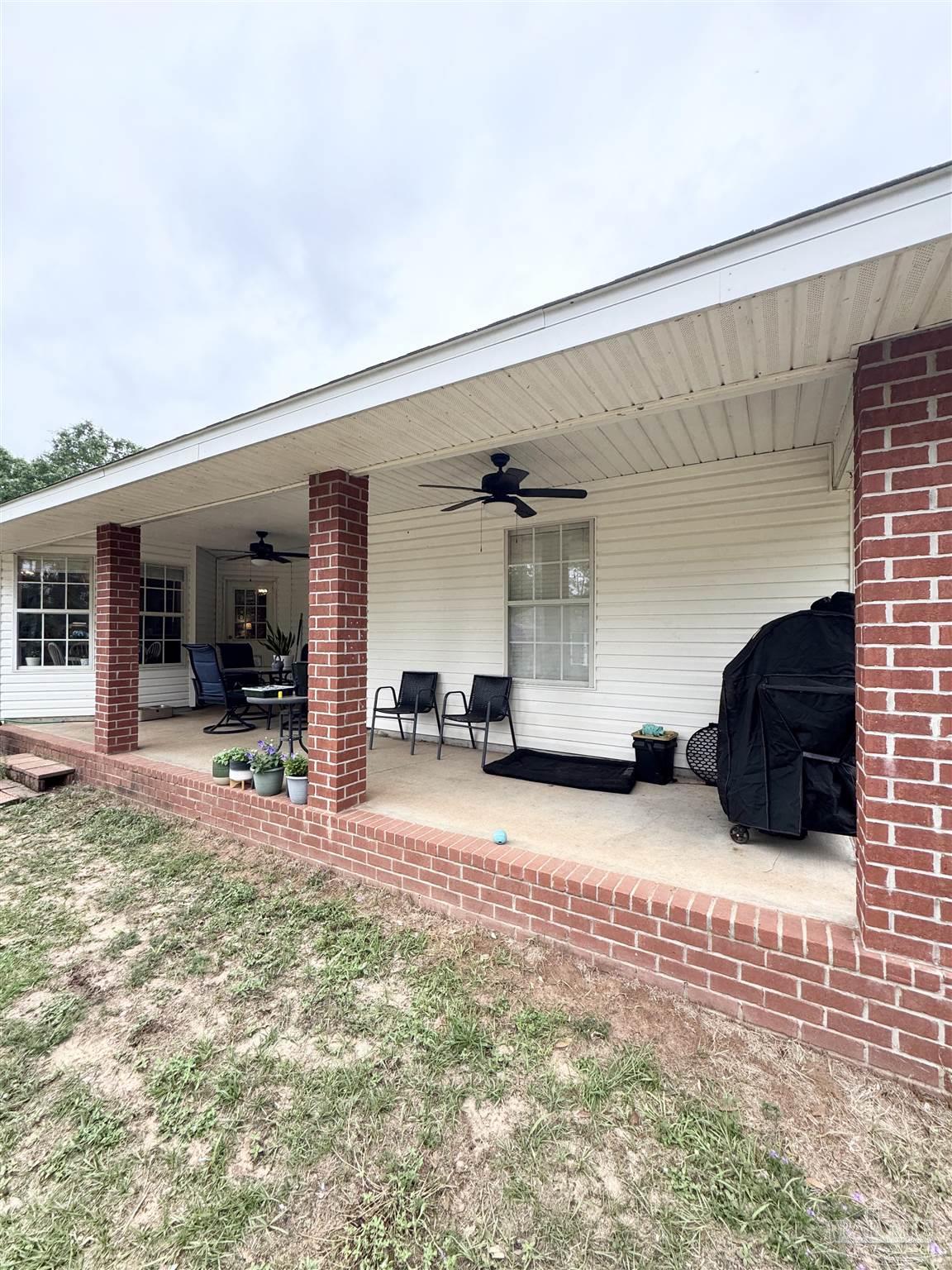 9909 South Trace Road Milton, FL 32583 - Photo 35 of 41 a view of a house with backyard and porch