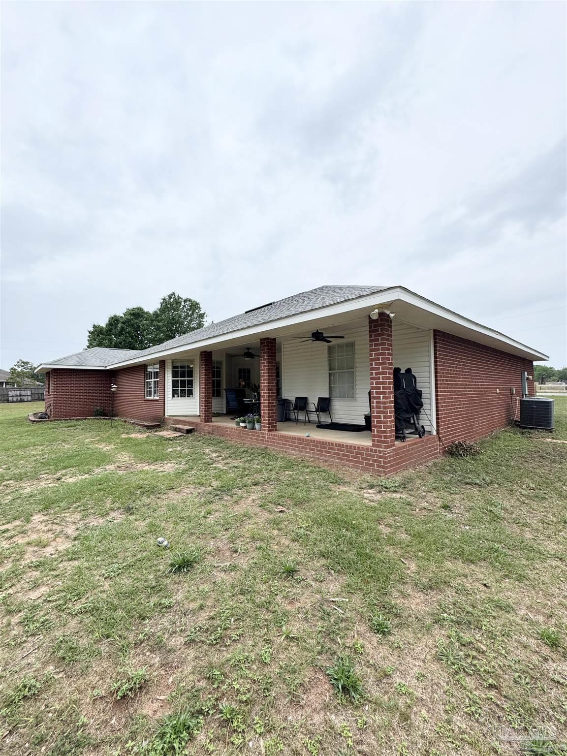 9909 South Trace Road Milton, FL 32583 - Photo 36 of 41 a view of a house with a yard