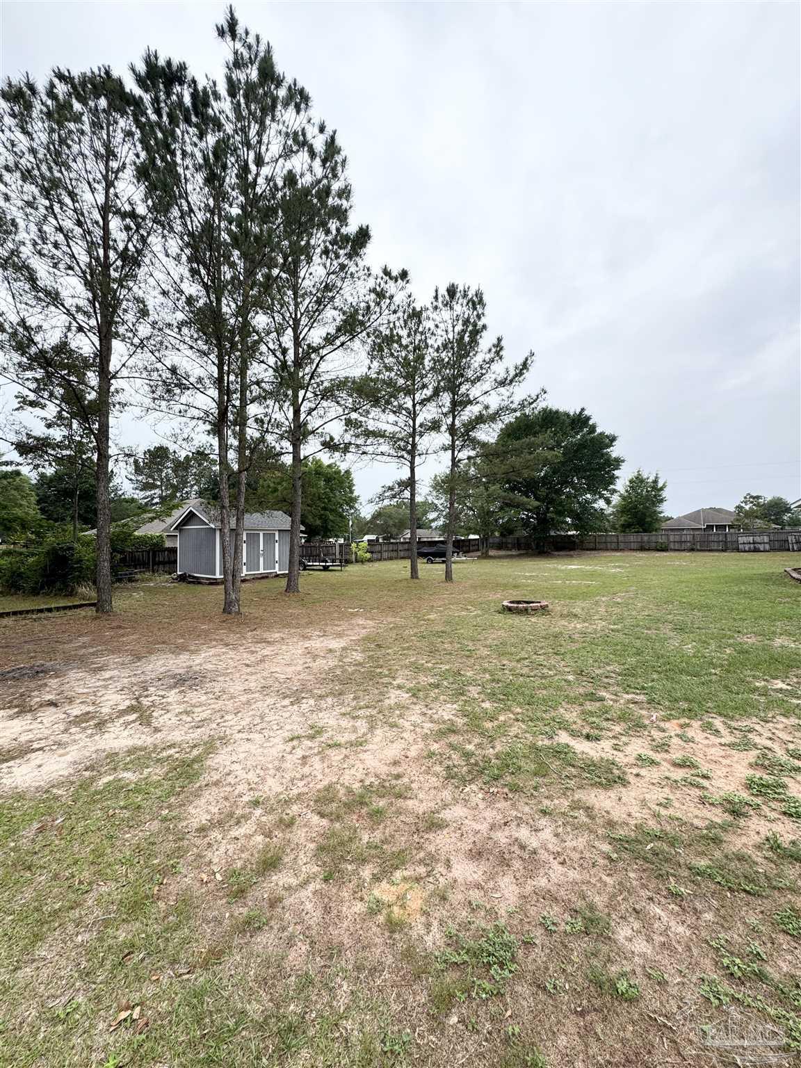 9909 South Trace Road Milton, FL 32583 - Photo 38 of 41 a view of a field with trees in front of it