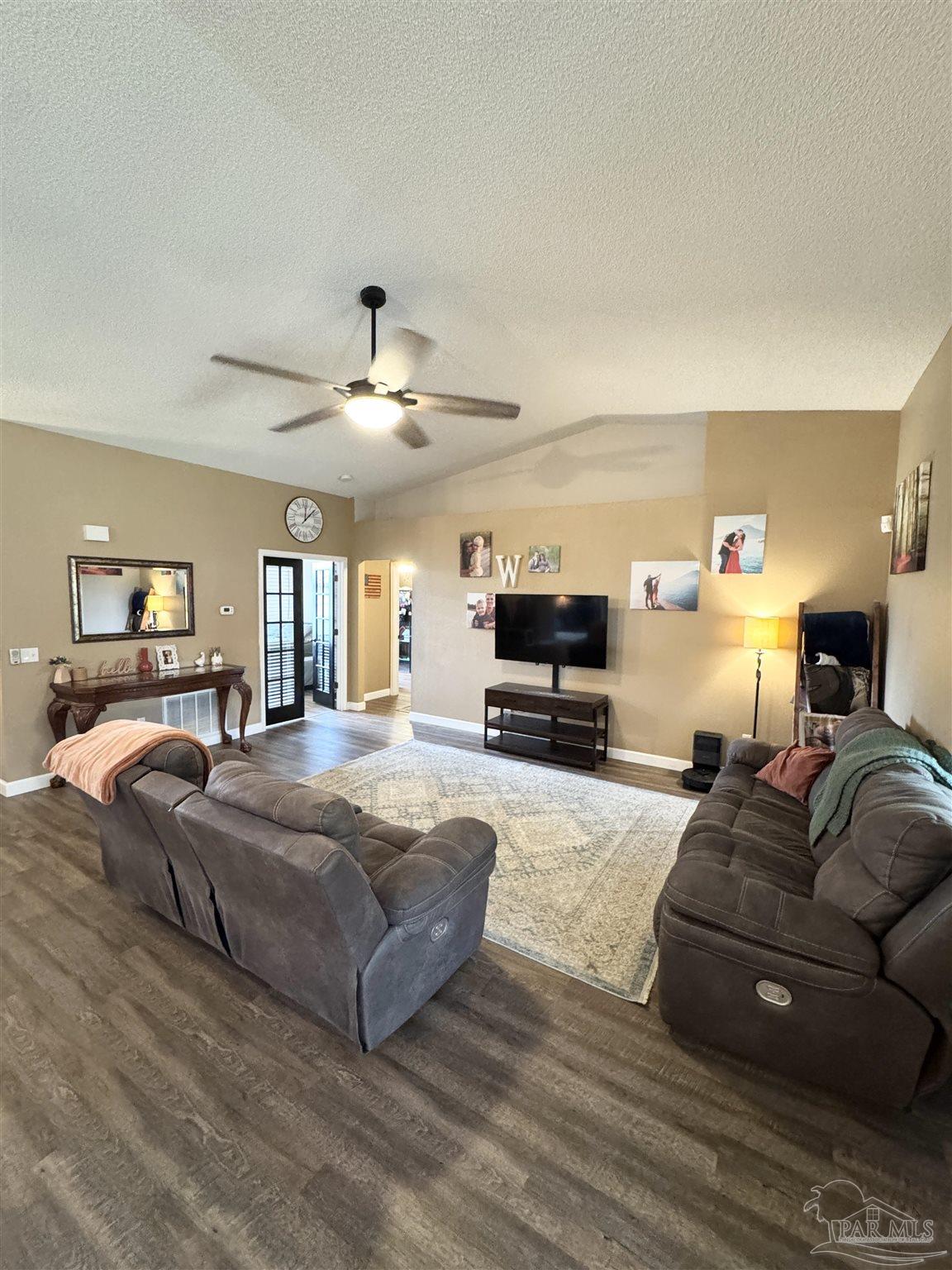 9909 South Trace Road Milton, FL 32583 - Photo 6 of 41 a living room with furniture and a flat screen tv