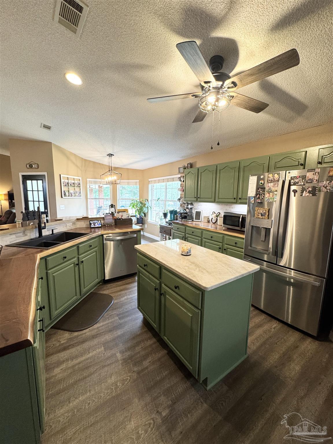 9909 South Trace Road Milton, FL 32583 - Photo 10 of 41 a kitchen with a sink cabinets and stainless steel appliances