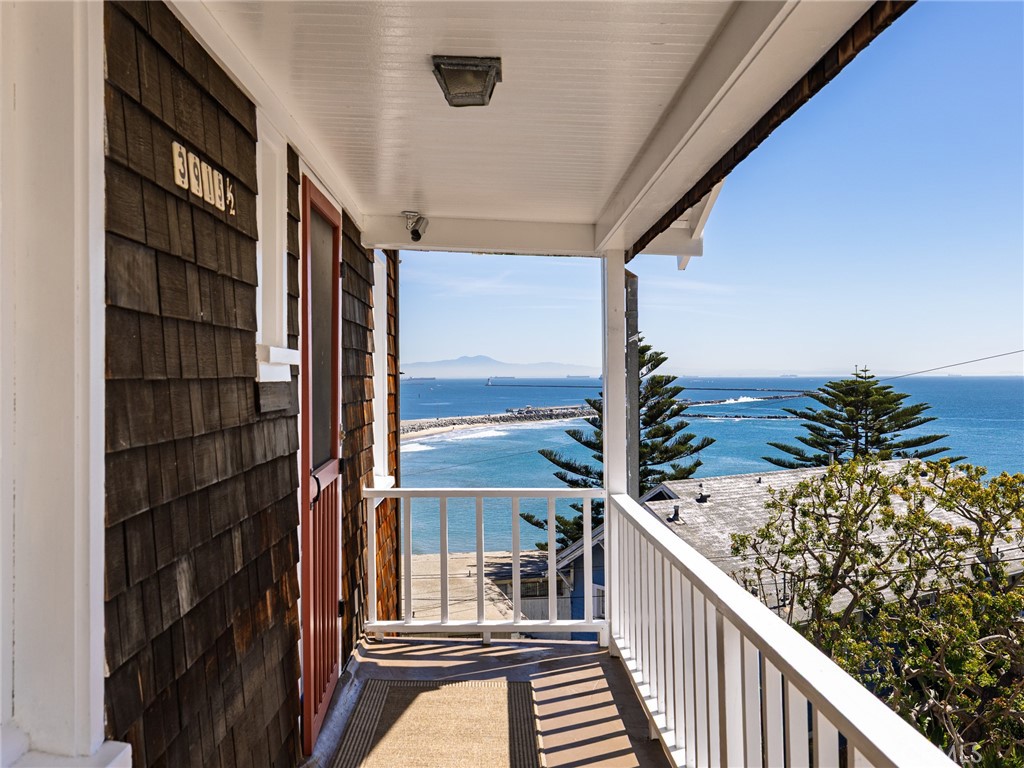 a view of balcony with floor to ceiling window and wooden floor