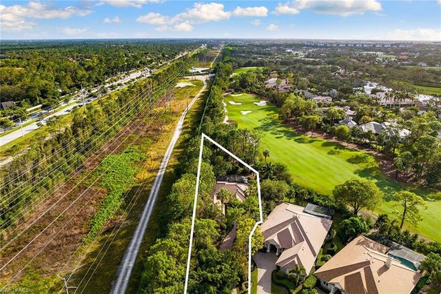 an aerial view of residential houses with outdoor space and city view