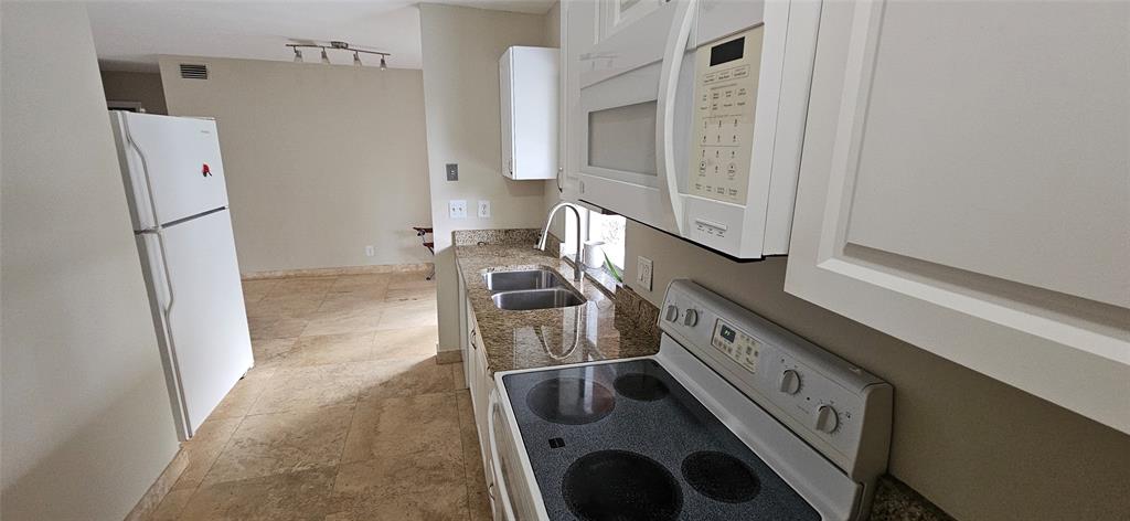 501 Northwest 65th Avenue Margate, FL 33063 - Photo 11 of 29 a kitchen with granite countertop a sink and a stove with refrigerator