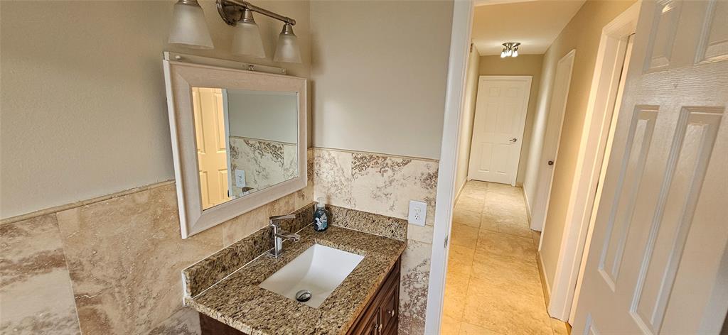 501 Northwest 65th Avenue Margate, FL 33063 - Photo 12 of 29 a bathroom with a granite countertop sink a mirror and shower