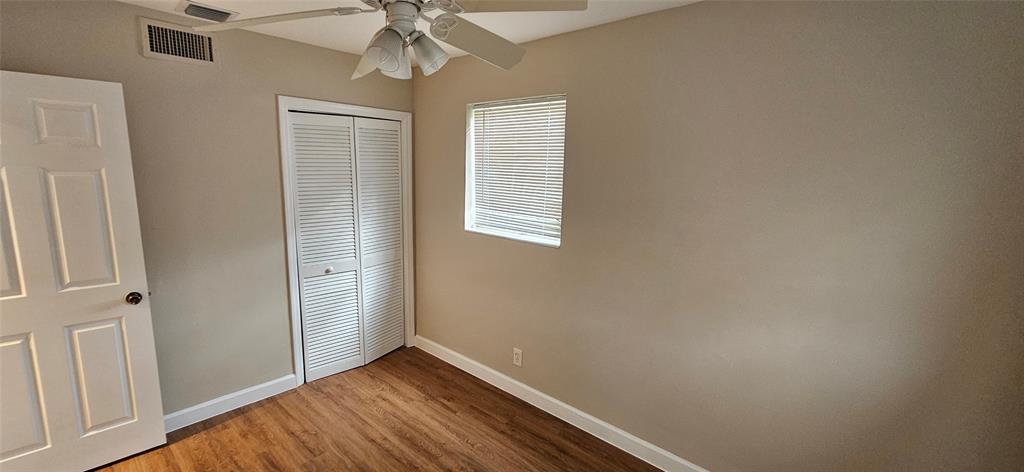 501 Northwest 65th Avenue Margate, FL 33063 - Photo 17 of 29 an empty room with wooden floor closet and windows
