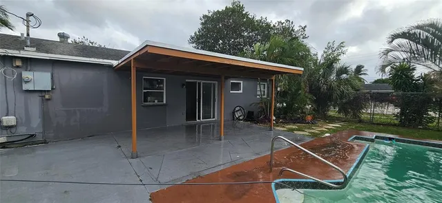 a backyard of a house with table and chairs