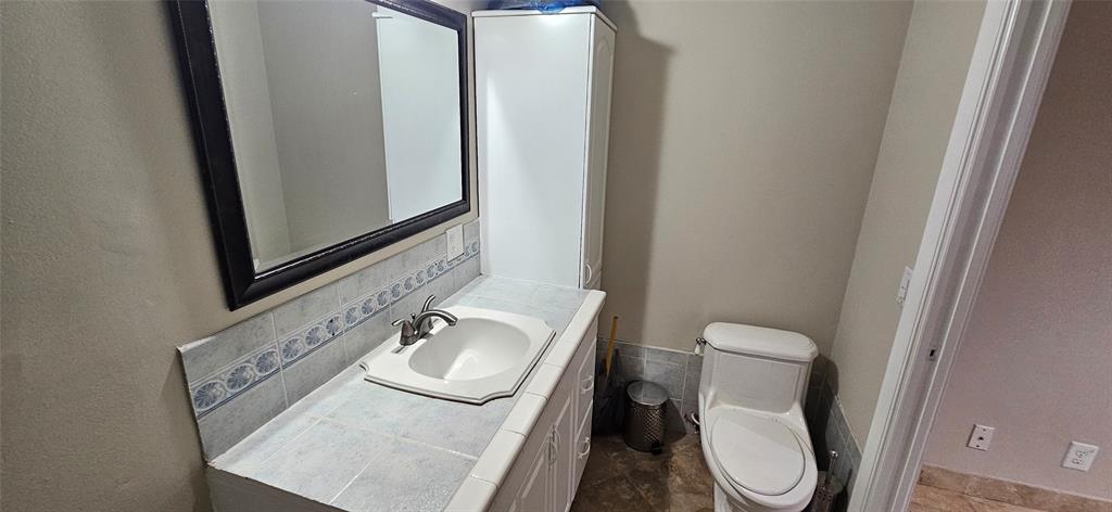 501 Northwest 65th Avenue Margate, FL 33063 - Photo 22 of 29 a bathroom with a toilet sink and mirror