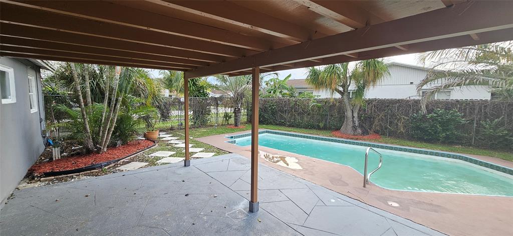 501 Northwest 65th Avenue Margate, FL 33063 - Photo 24 of 29 a swimming pool with outdoor seating and yard