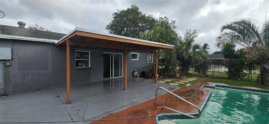 501 Northwest 65th Avenue Margate, FL 33063 - Photo 3 of 29 a backyard of a house with table and chairs