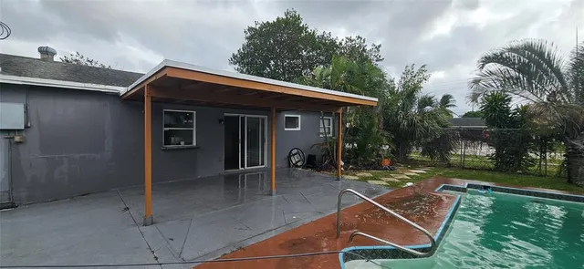 a backyard of a house with table and chairs