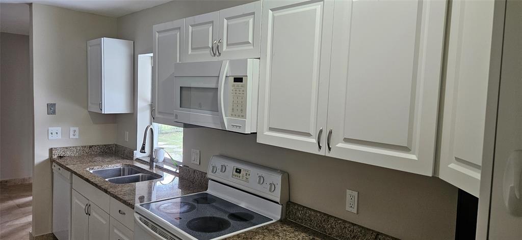 501 Northwest 65th Avenue Margate, FL 33063 - Photo 8 of 29 a kitchen with stainless steel appliances granite countertop a stove and a refrigerator