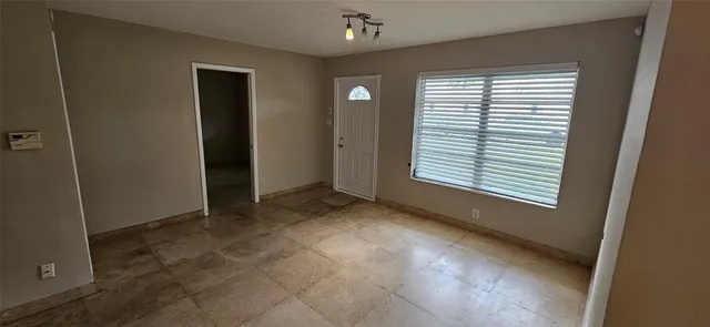 an empty room with windows and closet