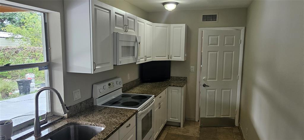 501 Northwest 65th Avenue Margate, FL 33063 - Photo 9 of 29 a kitchen with granite countertop a stove a sink and a microwave