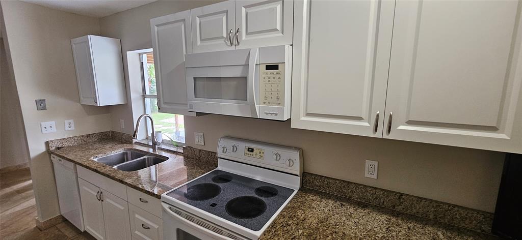 501 Northwest 65th Avenue Margate, FL 33063 - Photo 10 of 29 a kitchen with stainless steel appliances granite countertop a sink stove and cabinets