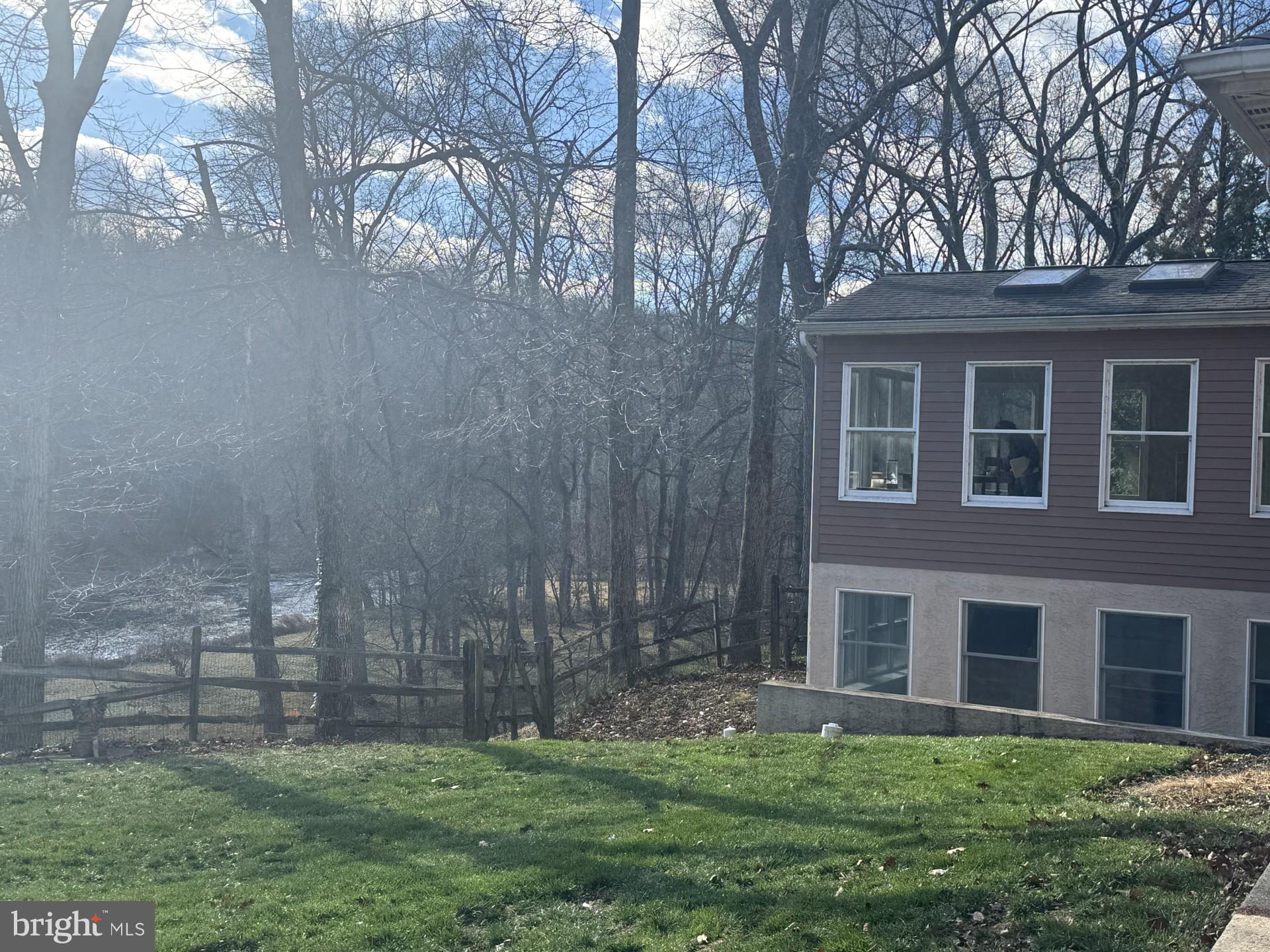 880 Macclesfield Road Furlong, PA 18925 - Photo 3 of 7 a brick house next to a yard with large trees