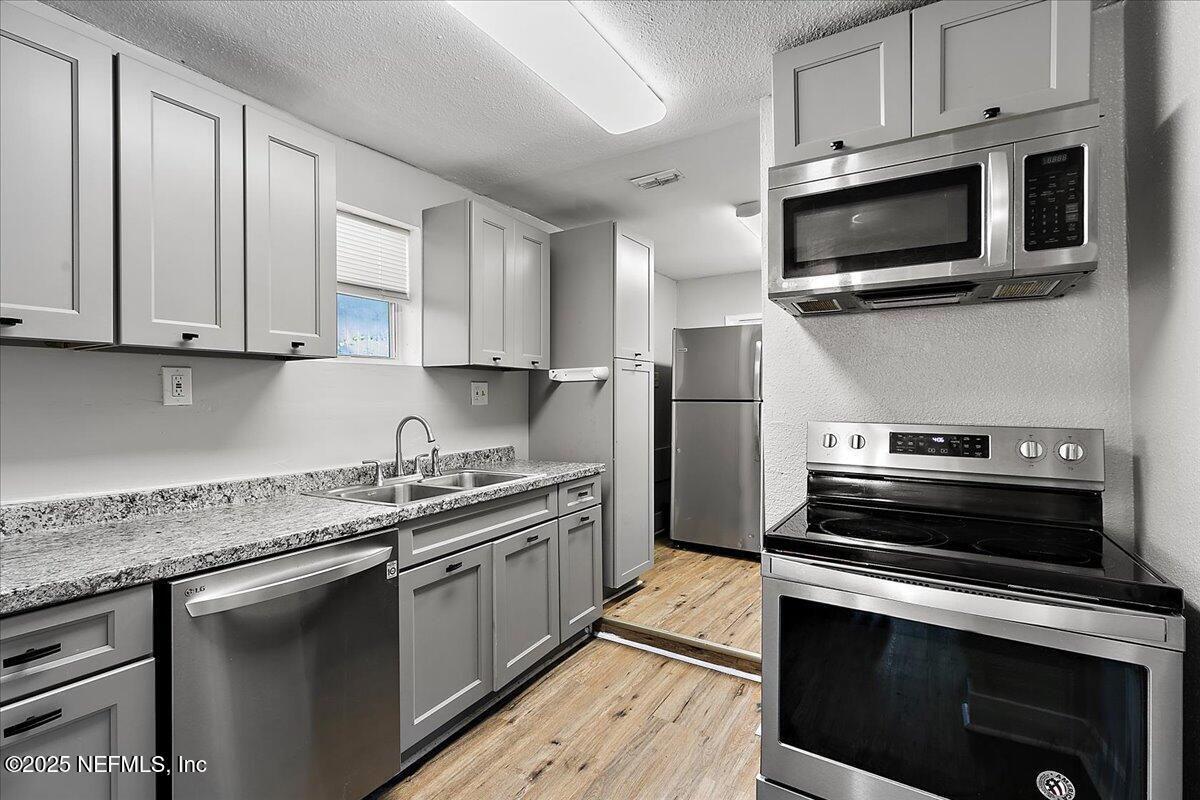 3607 Gilmore Street Jacksonville, FL 32205 - Photo 3 of 13 a kitchen with a sink stove and microwave