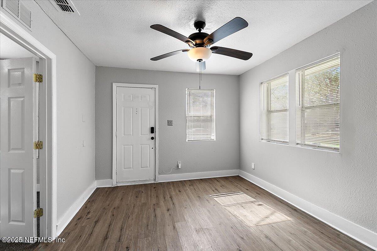 3607 Gilmore Street Jacksonville, FL 32205 - Photo 4 of 13 a view of an empty room with wooden floor and a window