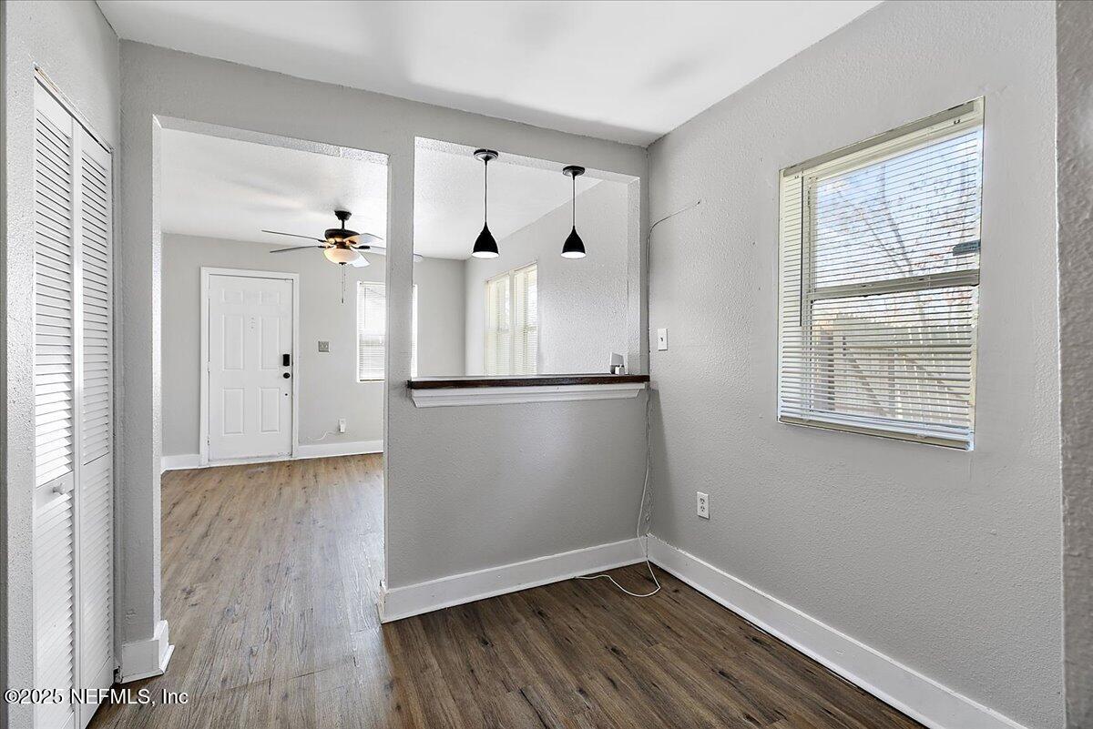 3607 Gilmore Street Jacksonville, FL 32205 - Photo 6 of 13 an empty room with wooden floor cabinet and windows