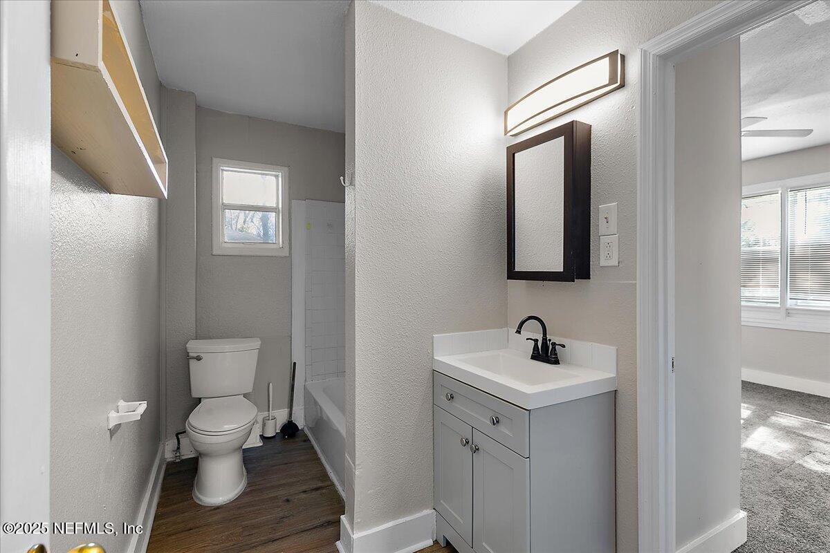 3607 Gilmore Street Jacksonville, FL 32205 - Photo 9 of 13 a bathroom with a toilet a sink and mirror
