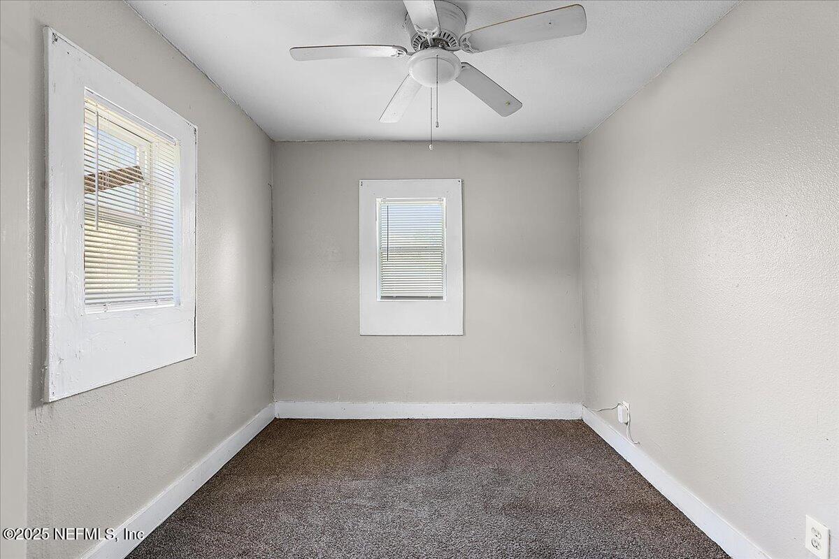 3607 Gilmore Street Jacksonville, FL 32205 - Photo 10 of 13 an empty room with a window and a ceiling fan