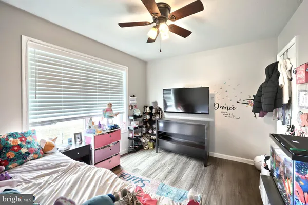 a bedroom with furniture and a flat screen tv