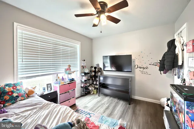 a bedroom with furniture and a flat screen tv