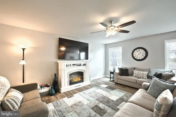 a living room with furniture a fireplace and a flat screen tv