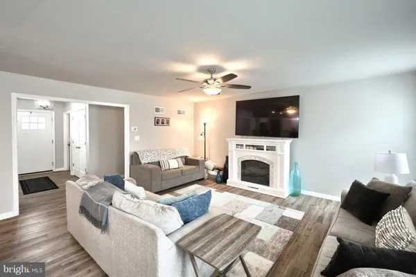 a living room with furniture a fireplace and a flat screen tv