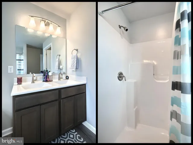 a bathroom with a sink mirror and shower