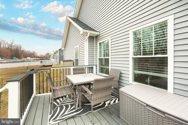 a balcony with table and chairs
