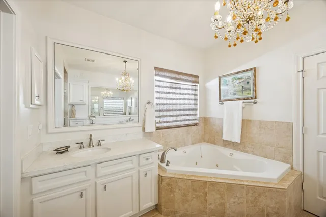 a spacious bathroom with a double vanity sink a shower and a mirror