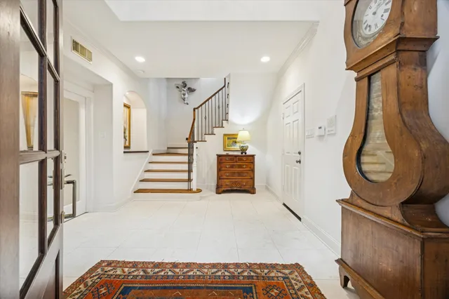 a kitchen with white cabinets and sink