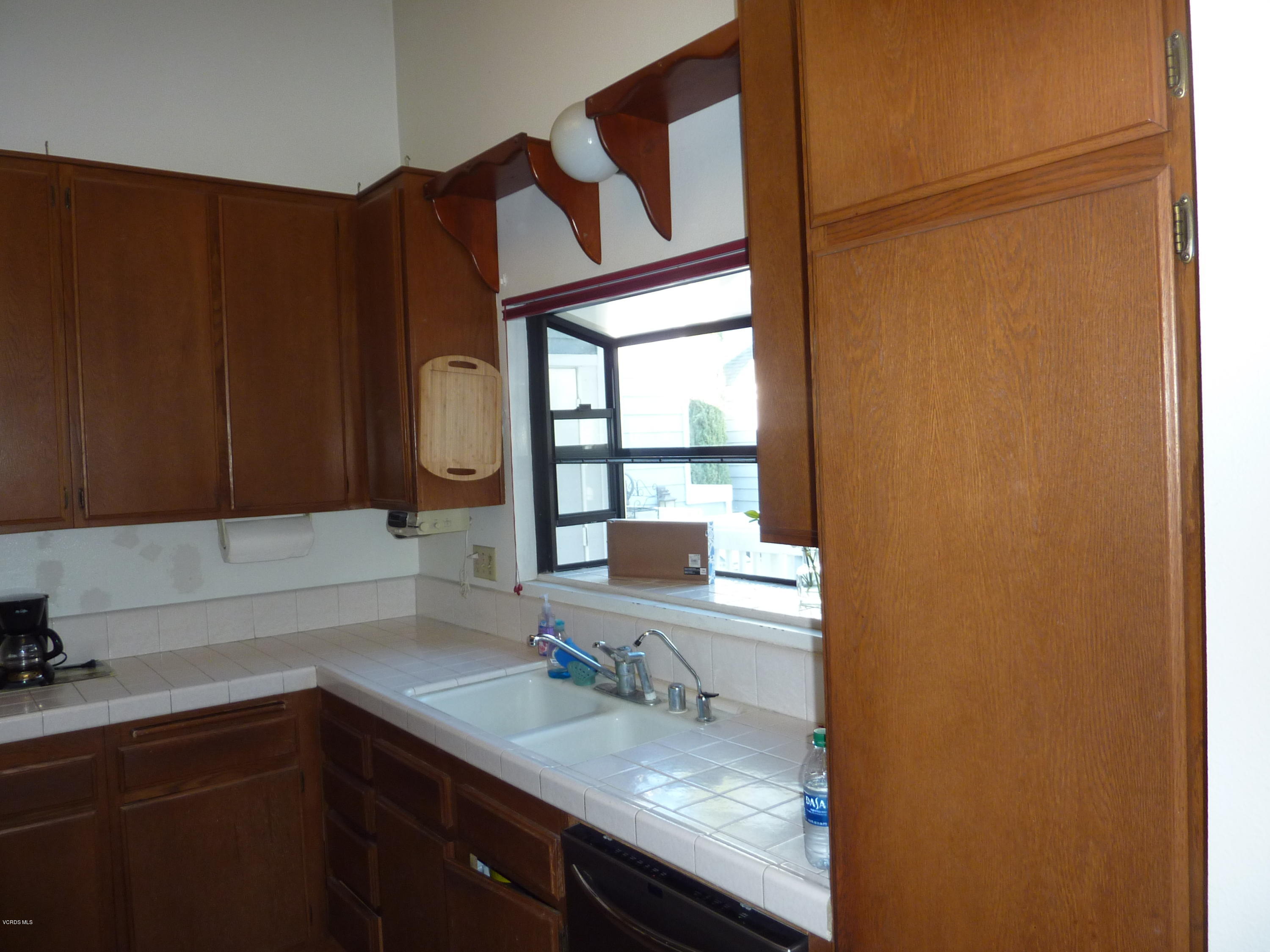 677 Arneill Road Camarillo, CA 93010 - Photo 18 of 40 a kitchen with a sink a window and cabinets